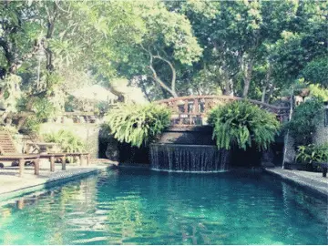 A view of the swimming pool with bridge over Besakih Beach Hotel